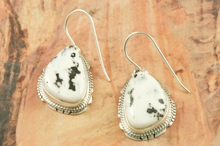 White Buffalo Turquoise set in Sterling Silver French Wire Earrings. This Beautiful Stone is formed from the minerals Calcite and Iron. It is mined near Tonopah Nevada. Created by Navajo Artist Larson Lee. Signed by the artist.